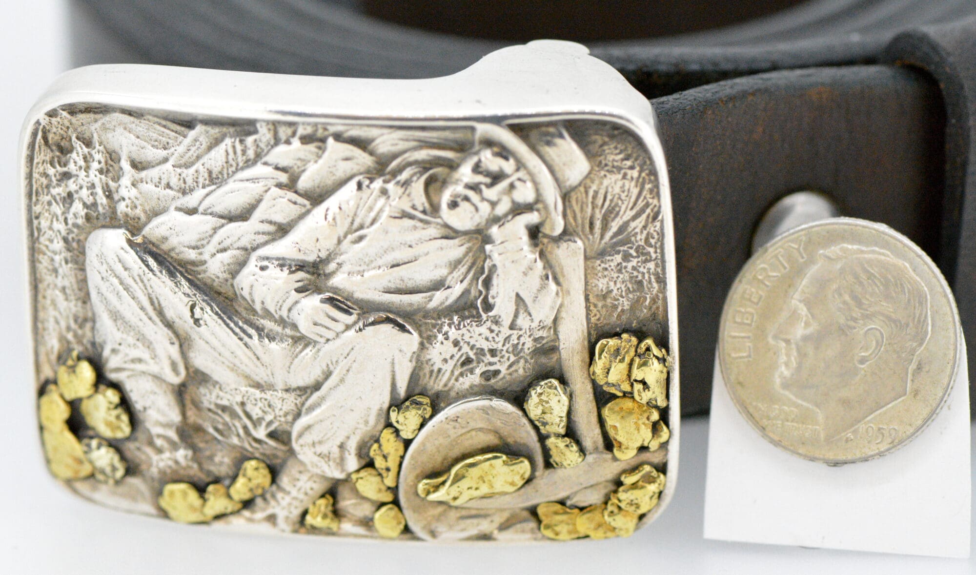 Belt buckle encrusted with gold nuggets and coins