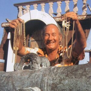 Mel Fisher holding gold money chains and other treasure
